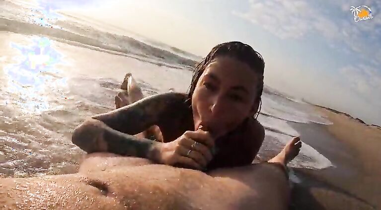 Real couple having fun on a nudist beach. Sexy wet blowjob